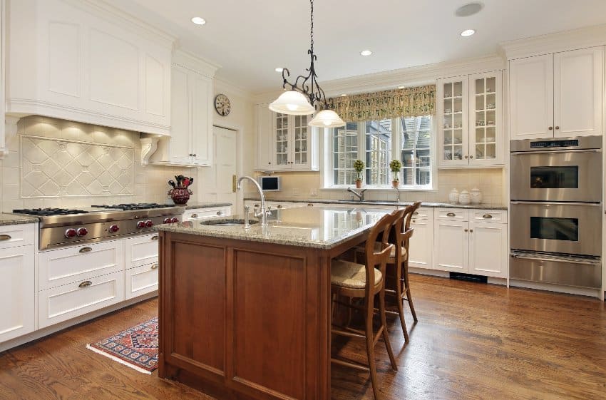 Classic kitchen style with wooden floors, white colonial cabinetry and center island