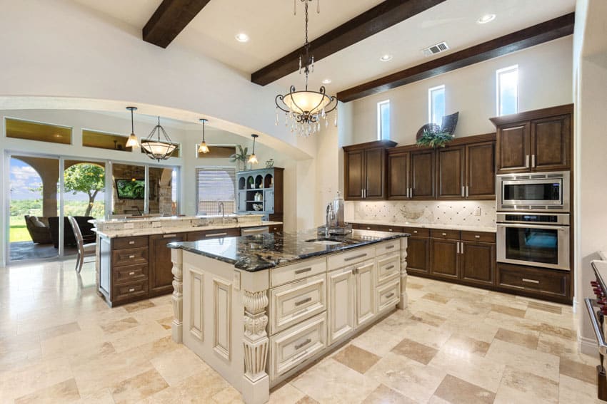 Classic kitchen with tile flooring, island, countertops, octagon, backsplash, wood cabinets, pendant light, oven, and exposed wood beams