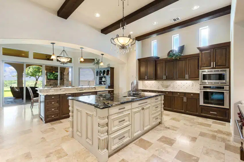 Classic kitchen with tile flooring, wood cabinets, pendant light and exposed wood beams