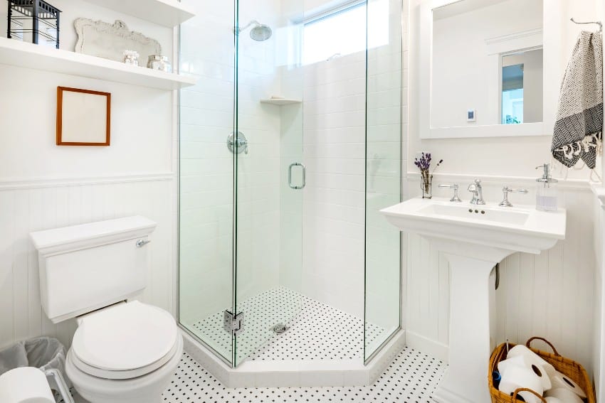 Clean white bathroom with subway tile, glass stand up shower, and traditional pedestal sink