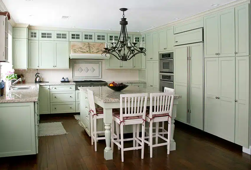 Colonial style kitchen with mint green cabinets chandelier white granite countertops