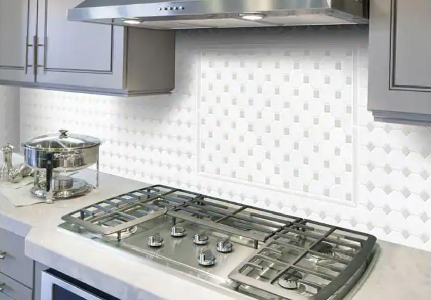 Octagon mosaic tile with countertop stove in stainless steel and metallic gray cabinets