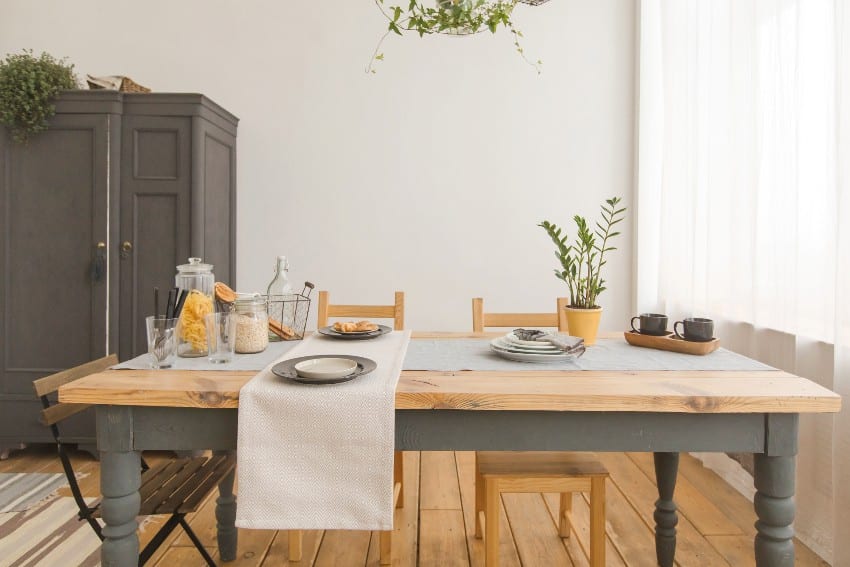 Dining italian alder chairs and table in modern home with elegant table setting