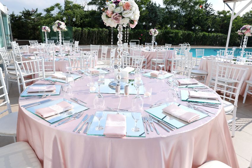 Elegant wedding table set up with old rose satin tablecloth