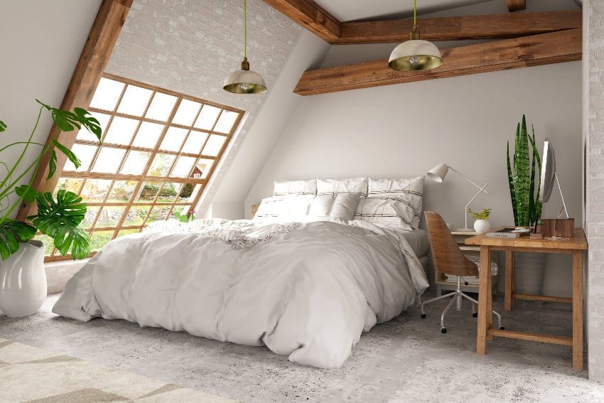 Gorgeous modern cottage style bedroom interior with exposed wood beams, cozy bed, wooden furniture, and ceiling lamps