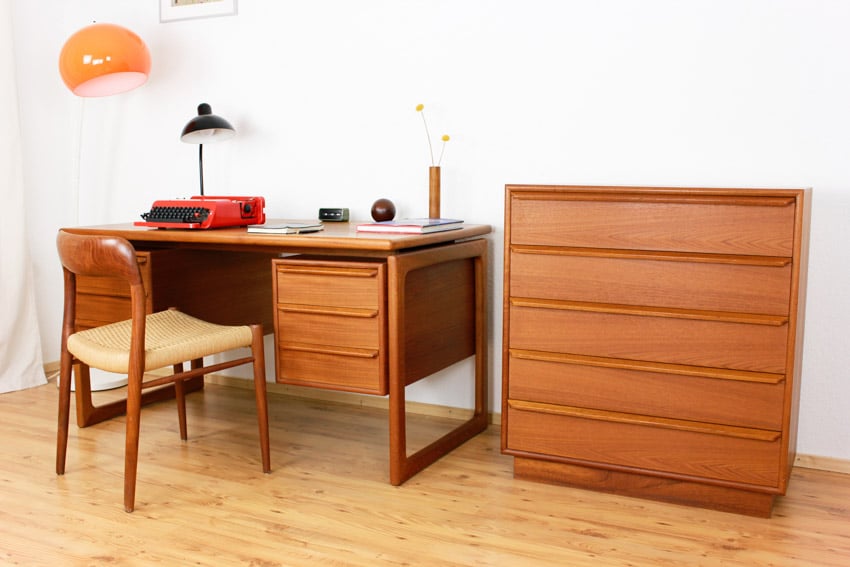 Home office area with teak wood desk, chair, cabinet, lamp, and wooden flooring