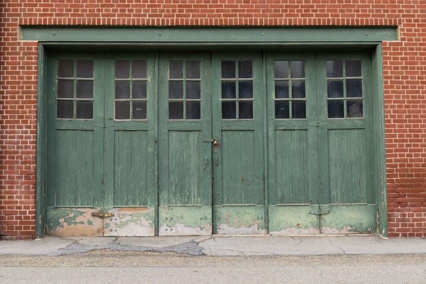 House with brick wall and manual doors