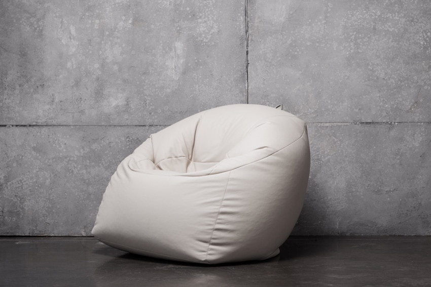 Industrial style room with concrete walls and bean bag chair