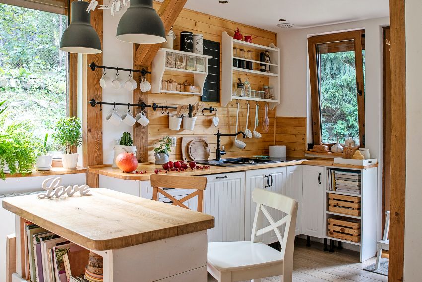 Interior of kitchen in vintage rustic style with rustic wood backsplash and wooden furniture in a cottage