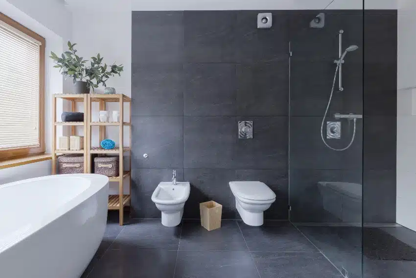 Luxury black and white bathroom with two toilet bowls, bathtub and shower with glass cover and waterproof vinyl tile