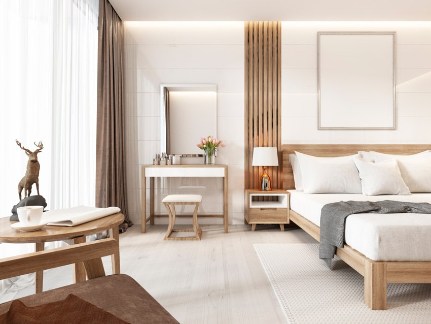 Minimalist bedroom with maple wood, stool, bed frame, table, vanity area, nightstand, lamp, mattress, pillows, and window curtains