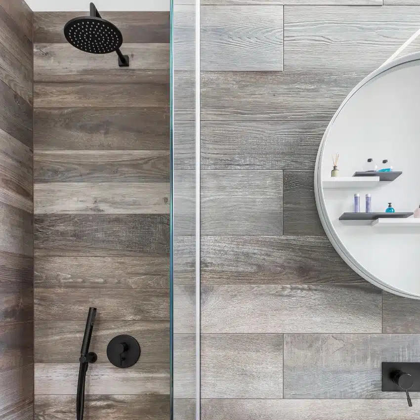 Modern bathroom with shower, wood vinyl tiling and round mirror on the side