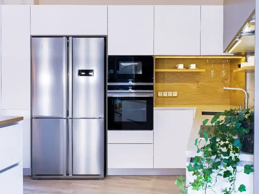 Modern fitted kitchen design in light interior with European furniture