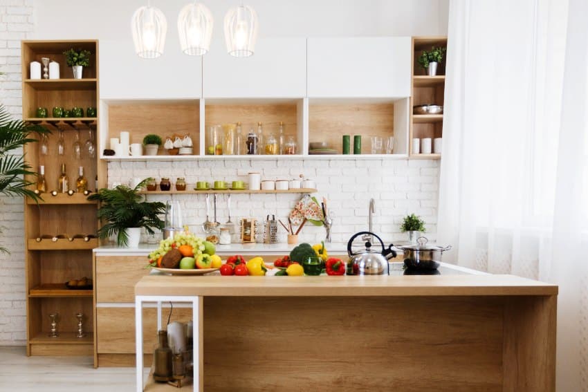 Modern light wooden kitchen with rustic limestone backsplash and island