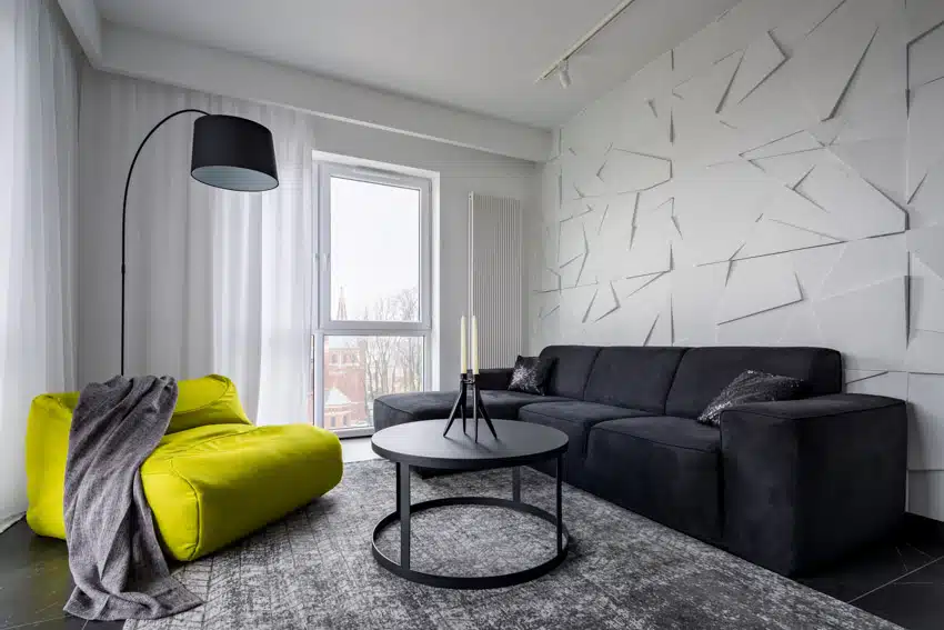 Lime green chair, black side table and couch with accent wall