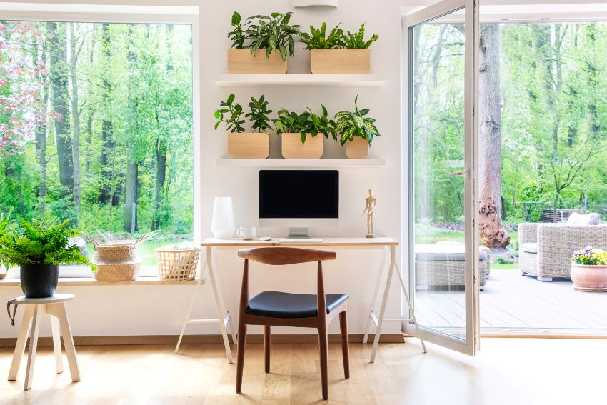 Nature inspired accent wall in home office with computer in a beautiful, spacious living room interior with plants