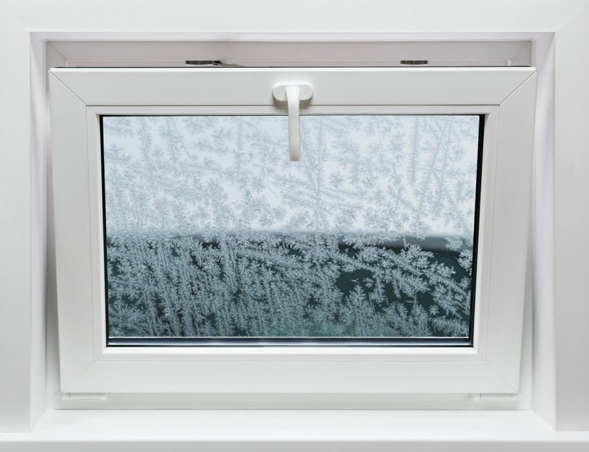 Open hopper window with white frame for basements