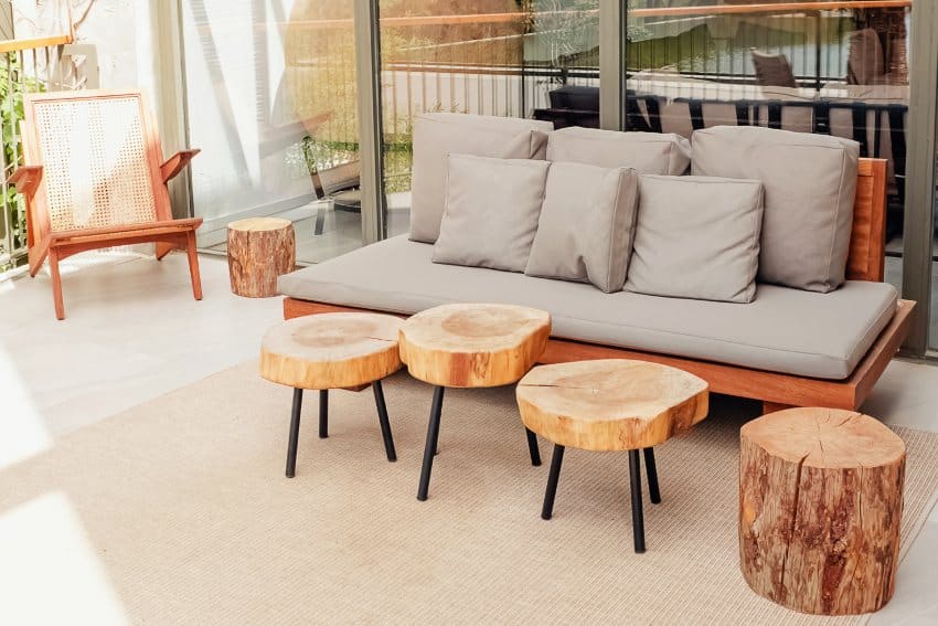 Outdoor alder wood sofa and coffee tables on cozy stylish modern terrace