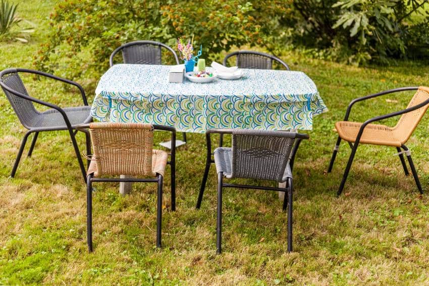 Outdoor summer casual garden party table set up with oilcloth tablecloth