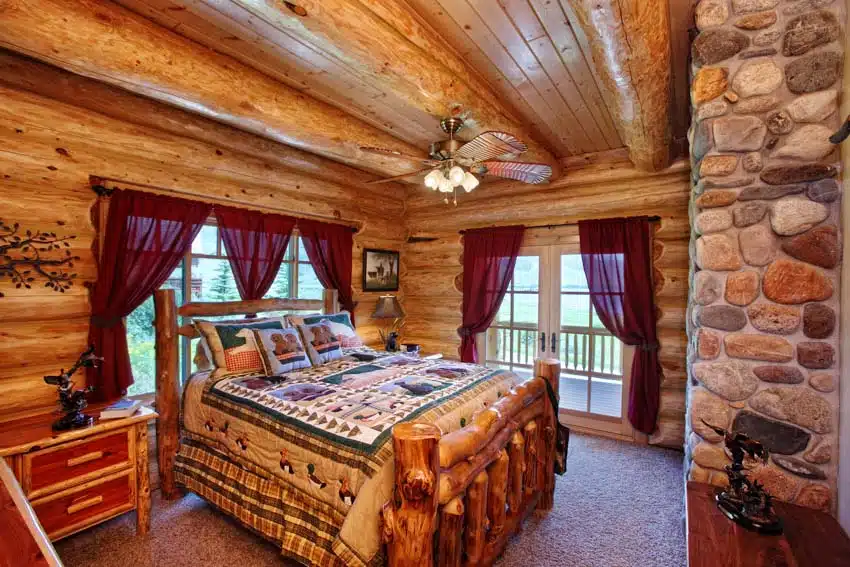 Rustic bedroom with aspen wood bed frame, mattress, ceiling fan, window, curtains, and nightstand