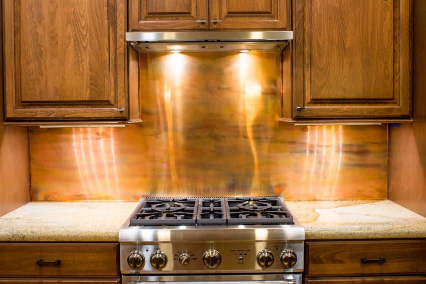Rustic copper kitchen backsplash and custom lighting