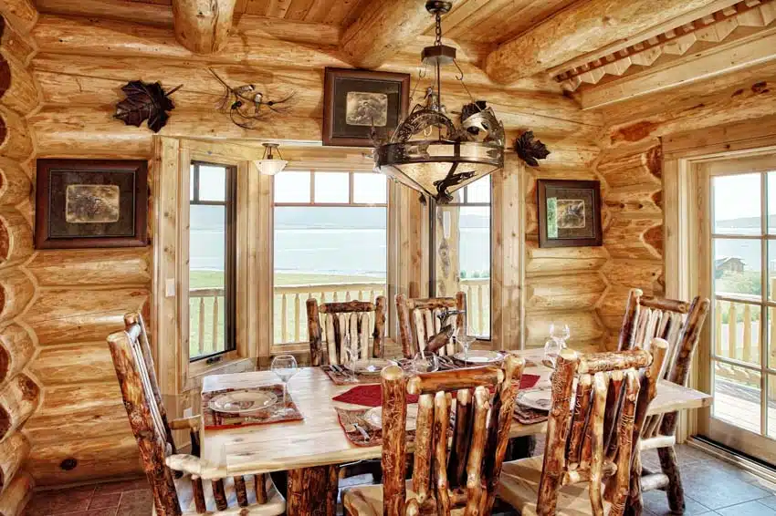 Rustic dining room with aspen wood table, chairs, windows, and chandelier