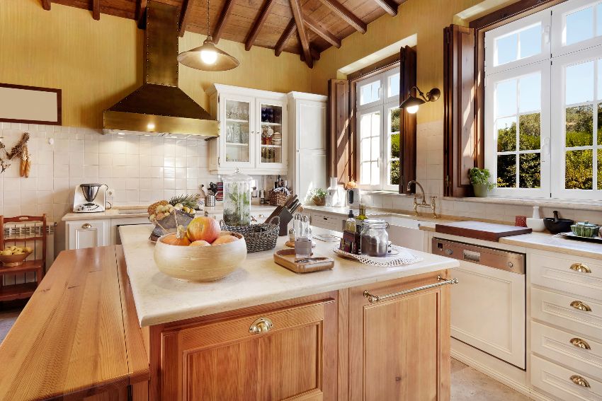 Rustic modern kitchen interior with white cabinets, rustic tile backsplash, island with fruits and condiments