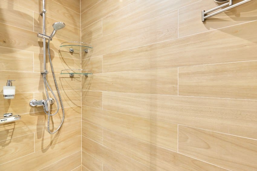 Shower with vinyl plank walls and showerhead