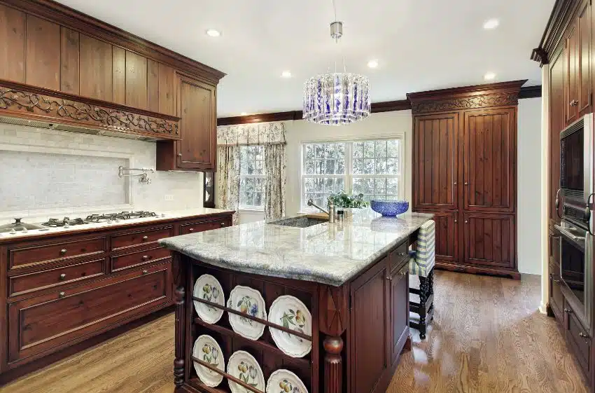 Traditional kitchen with dark wood colonial cabinetry and marble island countertop