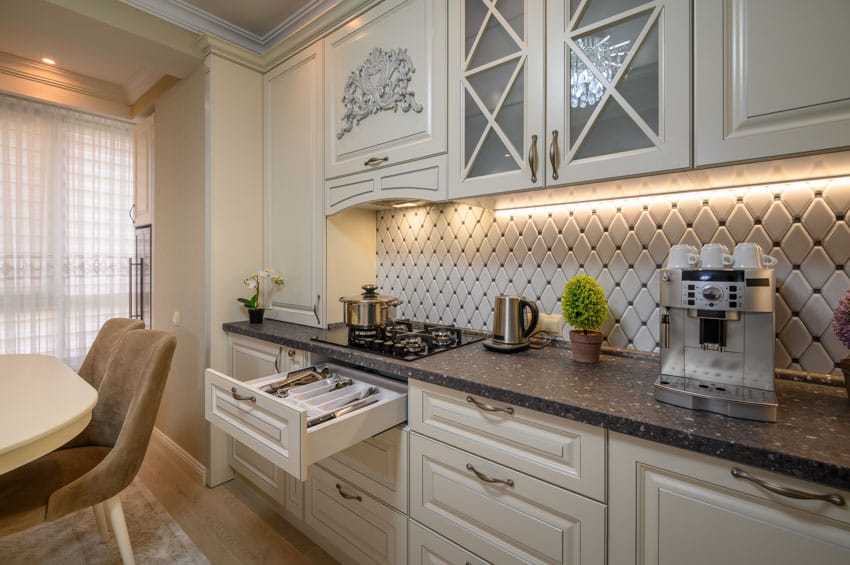 Victorian kitchen with octagon backsplash, white cabinets, drawers and under cabinet lighting