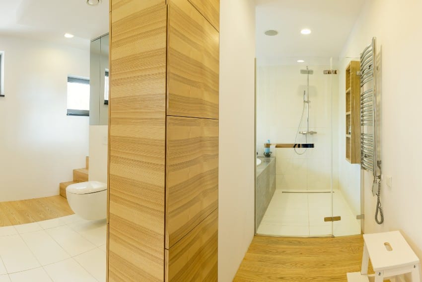 Vinyl wood walls and floors in white spacious shower and bathroom