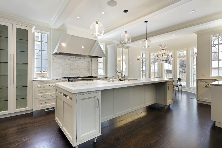 White kitchen features island and kitchen cabinets