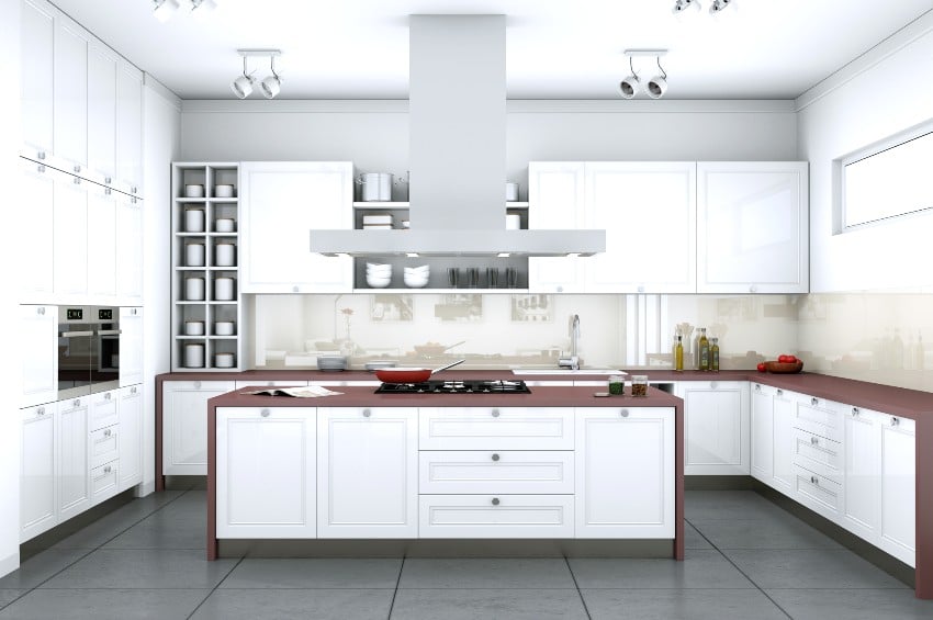 White modern kitchen features kitchen cabinets with legs in a flat with beautiful design