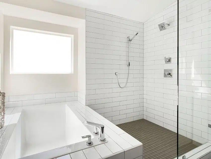 Bathroom with tub subway tile mosaic floor