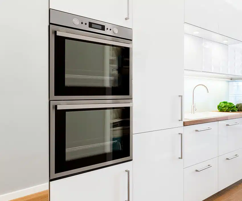 Modern white kitchen with wall oven