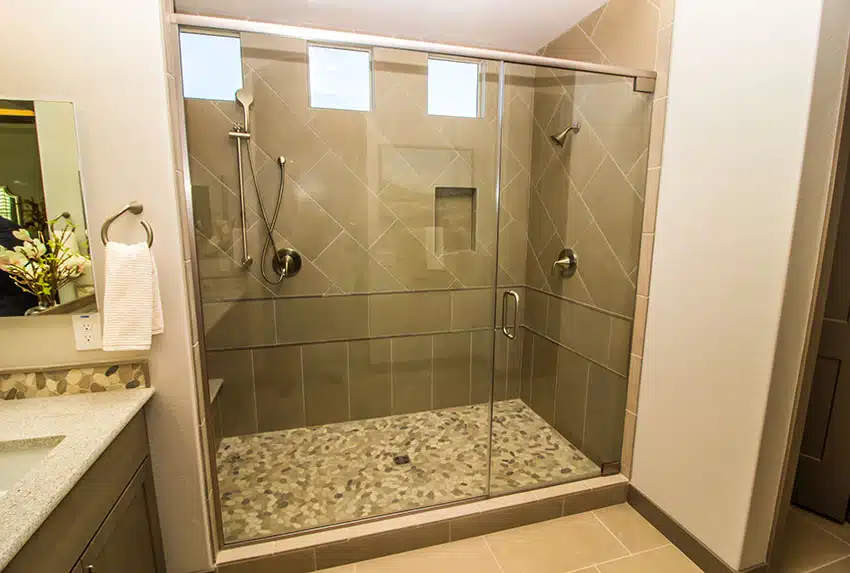 Shower with glass doors niche mosaic floor tile in shower