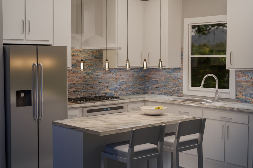 Kitchen with backsplash made of ledger stones, refrigerator, pendant lights, faucet, and sink