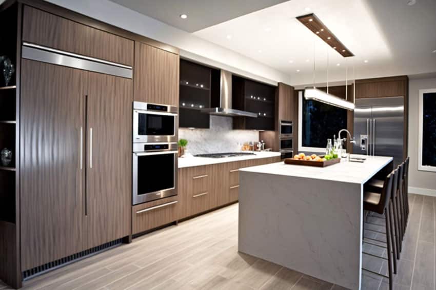 Contemporary kitchen with waterfall quartz island, oven, countertop, wood flooring, pendant light, backsplash, and vertical grain cabinets