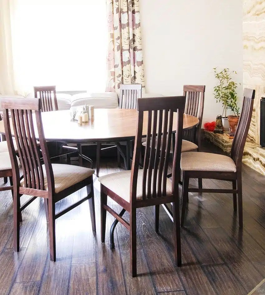 Dining area with fireplace, hardwood floors, wooden table and Stickley-style chairs