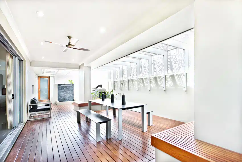 Room with wood plank flooring, dining set in metal finish and ceiling fan