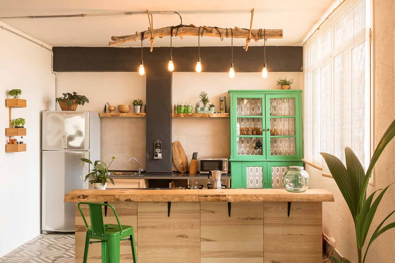 bohemian kitchen with live edge peninsula, and custom driftwood lighting fixture