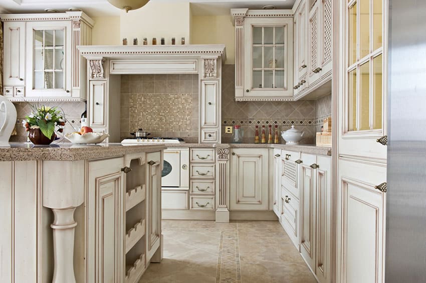 French country kitchen with tile backsplash, granite countertop, white washed cabinets, and range hood