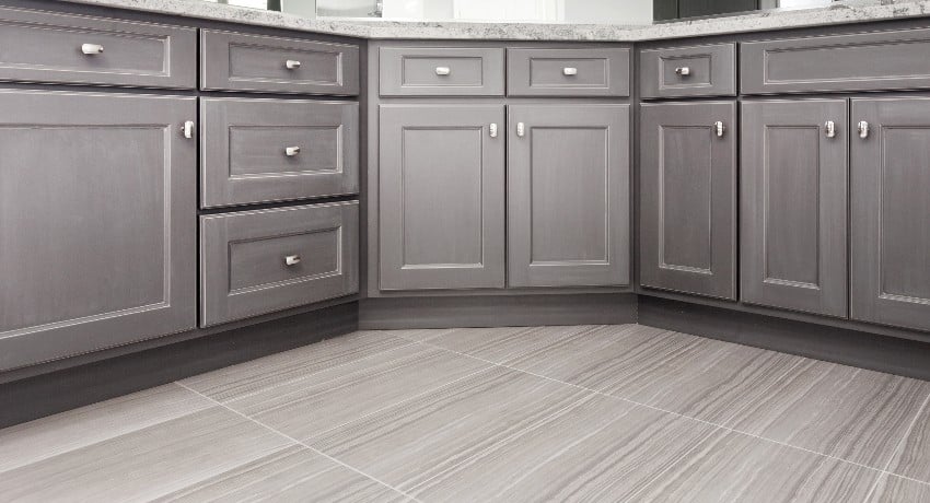 Gray RTF cabinets with chrome color rectangular handles and porcelain floor tiles