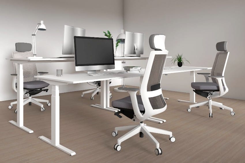Height adjustable desks and ergonomic chairs inside the office