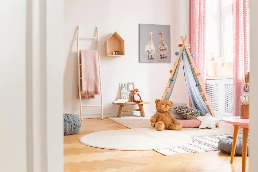 Kids playroom with tent, teddy bear, carpets and painting on the wall