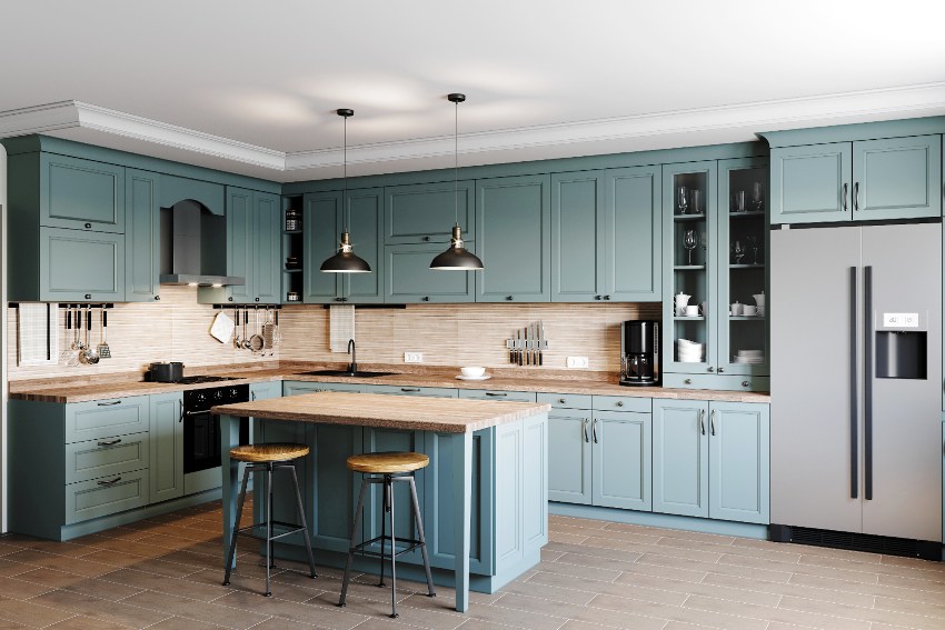 Kitchen with pastel light blue RTF cabinets, a wooden worktop with sink, stove, oven and kitchen utensils