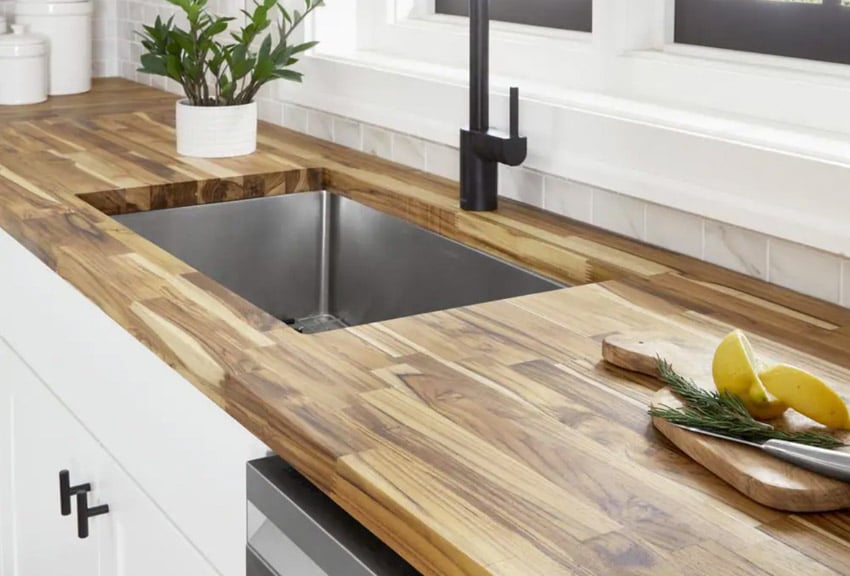 Kitchen with sink, faucet, cabinets, and unfinished teak wood countertop