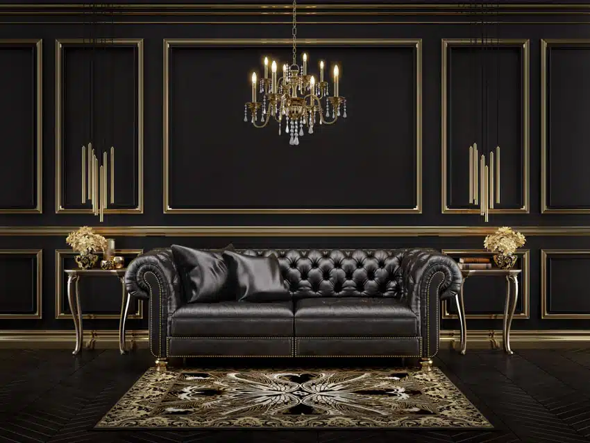 Living room with Hollywood regency style leather sofa, side table, rug, black and gold walls