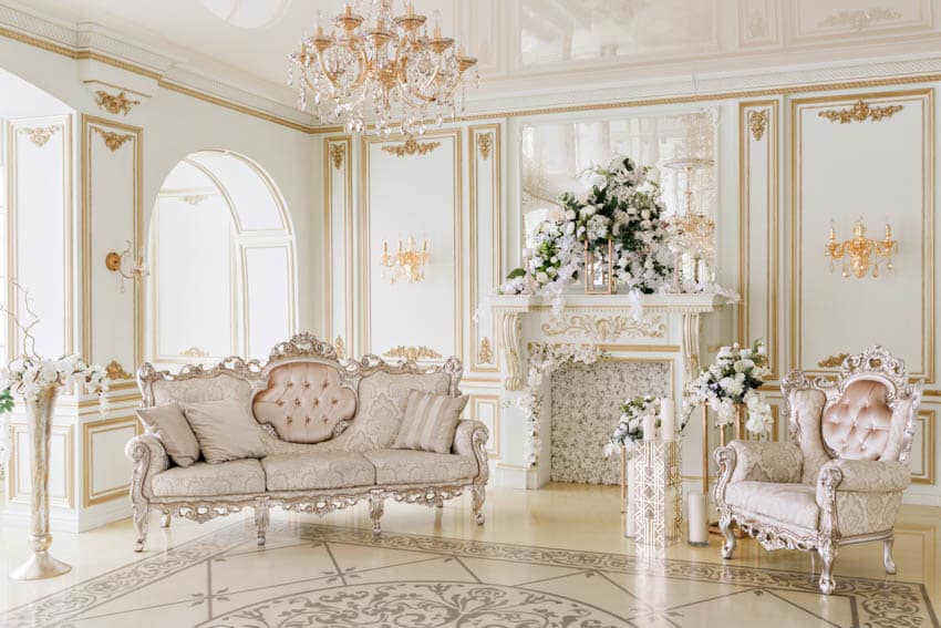 Luxury classic living room with French regency style furniture, sofa, accent chair, fireplace, tiled floors, fireplace, windows, and chandelier