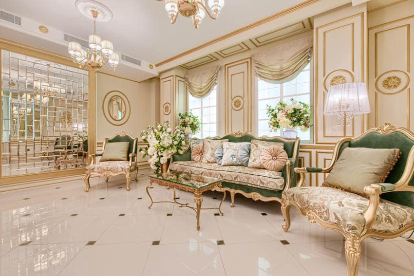 Luxury classic living room with regency style sofa, chair, tile floors, window, drapes, and chandeliers